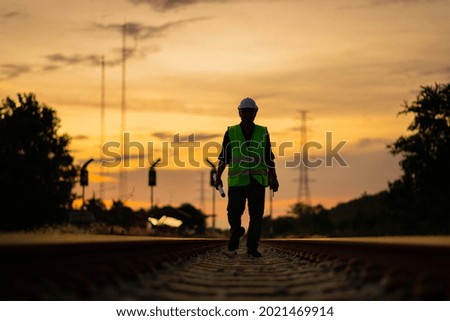 Engineer under inspection and checking construction process railway switch and checking work on railroad station .Engineer wearing safety uniform and safety helmet in work.
