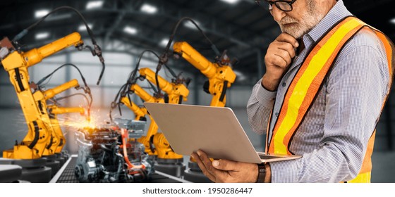 Engineer Use Advanced Robotic Software To Control Industry Robot Arm In Factory . Automation Manufacturing Process Controlled By Specialist Using IOT Software Connected To Internet Network .