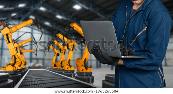 Engineer use advanced robotic software to control\
industry robot arm in factory . Automation manufacturing process\
controlled by specialist using IOT software connected to internet\
network .