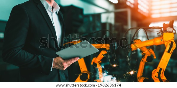 Engineer use advanced robotic software to control\
industry robot arm in factory . Automation manufacturing process\
controlled by specialist using IOT software connected to internet\
network .