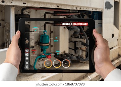 Engineer use augmented reality software in smart factory production line with automated application . Futuristic machinery in working in concept of Industry 4.0 or 4th industrial revolution.