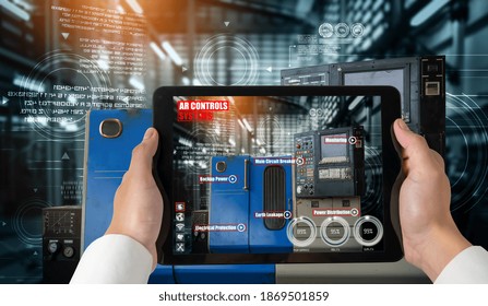 Engineer use augmented reality software in smart factory production line with automated application . Futuristic machinery in working in concept of Industry 4.0 or 4th industrial revolution.