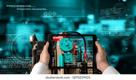Engineer use augmented reality software in smart factory production line with automated application . Futuristic machinery in working in concept of Industry 4.0 or 4th industrial revolution.