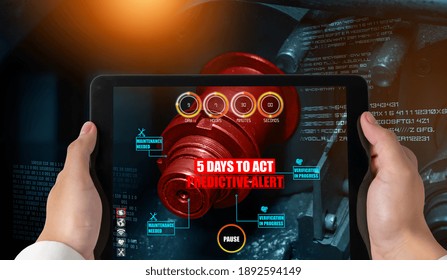 Engineer use augmented reality software in smart factory production line with automated application . Futuristic machinery in working in concept of Industry 4.0 or 4th industrial revolution.