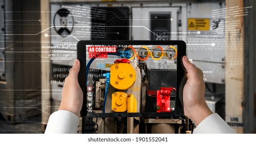 Engineer use augmented reality software in smart factory production line with automated application . Futuristic machinery in working in concept of Industry 4.0 or 4th industrial revolution.