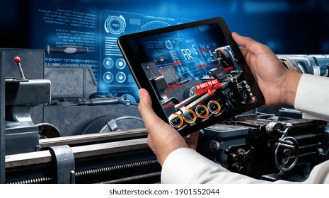 Engineer use augmented reality software in smart factory production line with automated application . Futuristic machinery in working in concept of Industry 4.0 or 4th industrial revolution.