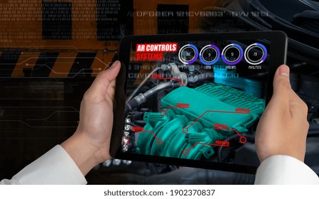 Engineer use augmented reality software to monitor parts of car vehicle with automated application . Futuristic machinery in working in concept of Industry 4.0 or 4th industrial revolution.