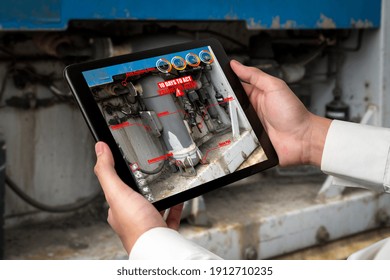 Engineer use augmented reality software in smart factory production line with automated application . Futuristic machinery in working in concept of Industry 4.0 or 4th industrial revolution.