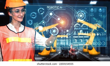 Engineer use cybernated robotic software to control industry robot arm in factory . Automation manufacturing process controlled by specialist using IOT software connected to internet network . - Shutterstock ID 2203154555