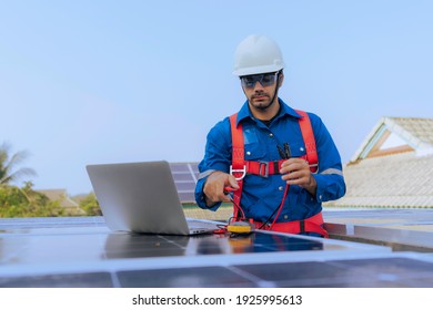 An Engineer Use A Laptop Computer To Examine, Inspection The Solar Panels At Roof Top Of Home And Home Office ,concept Of Economic Energy And Cost Saving