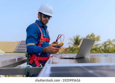 An Engineer use a laptop computer to examine, inspection the solar panels at roof top of home and home office ,concept of economic energy and cost saving - Shutterstock ID 1925995616