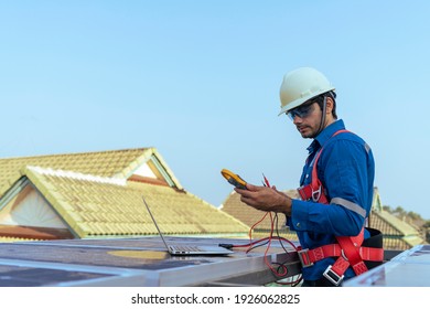 An Engineer Use A Laptop Computer To Examine, Inspection The Solar Panels At Roof Top Of Home And Home Office ,concept Of Economic Energy And Cost Saving