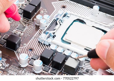 The engineer use multimeter to repairing the computer motherboard.