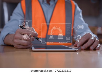 Engineer using digital tablet to control and monitor robotic arm system in smart factory. Industrial automation, predictive maintenance, and IoT technology in manufacturing innovation concept.