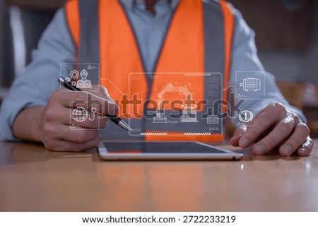 Engineer using digital tablet to control and monitor robotic arm system in smart factory. Industrial automation, predictive maintenance, and IoT technology in manufacturing innovation concept.