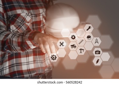 engineer is using future innovative technology, touching a holographic digital display panel with engineering options in order to manage her work, mixed media image with copy space for advertising