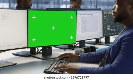 Engineer using green screen computer, working in server farm to optimize it for data processing requirements. IT professional coding on mockup PC in data center, camera A - Powered by Shutterstock - Get 15% off with code: PIKWIZARD15