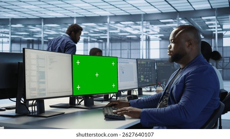 Engineer using green screen computer, working in server farm to optimize it for data processing requirements. IT professional coding on mockup PC in data center, camera A - Powered by Shutterstock - Get 15% off with code: PIKWIZARD15
