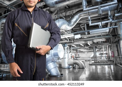 Engineer Using Laptop Computer In The Factory