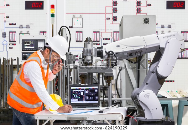 Engineer\
using laptop computer for maintenance automatic robotic hand\
machine tool at industrial, Industry 4.0\
concept