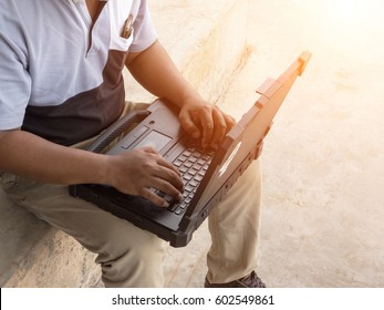 Engineer Using Laptop For Planing A Project At Factory Site.