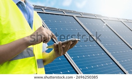 Engineer using a mobile app for remote monitoring and maintenance of a solar panel farm a concept of smart IoT technology and clean energy