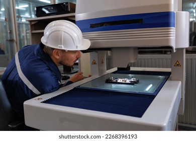 An engineer using optical micrometer quality checking micro part and close up look