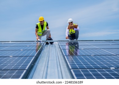 Engineer using pad to running solar system after installation, using solar cell in comercial in industrial level to save the world.