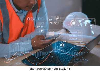 Engineer using smartphone and computer with futuristic charts interface for automation and monitoring Futuristic industrial automation, smart factory technology, monitoring innovation concept