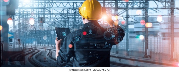Engineer using tablet checking and analysis data systems electrics of track on railway on networking, Modern Industrial and transportation.  - Shutterstock ID 2303075273