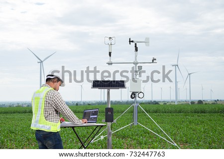 Engineer using tablet computer collect data with meteorological instrument to measure the wind speed, temperature and humidity and solar cell system on corn field, Smart agriculture technology concept