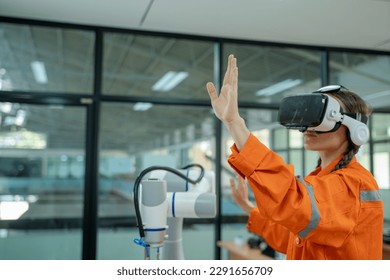 Engineer are using virtual AR to maintain of human robot and CNC machine at the 4.0 Smart Factory. - Powered by Shutterstock