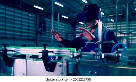 Engineer is using virtual reality glasses to inspect the factory's mechanical control system.