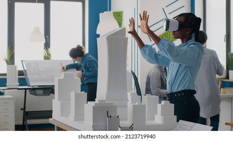 Engineer using vr glasses to design building model and construction for development. Woman architect working with virtual reality goggles to plan urban architecture project in office.