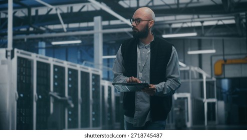 Engineer Utilizing Software in Data Center. Professional Male Engineer Uses Specialized App on Tablet to Monitor Performance of Enterprise Level Servers. Modern IT Tools and Technical Supervision.