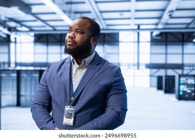 Engineer walking in data center, configuring and managing network infrastructure, such as routers, switches and firewalls. IT expert in server hub looking for technical issues
