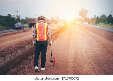 engineer walking and the measuring wheel road
