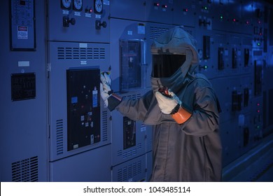 Engineer wear a arc flash protection suit for inspection electrical current 
 and checking status switch gear electrical energy distribution substation. - Shutterstock ID 1043485114