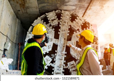Engineer to wear workwear clothing safety.Technician control underground tunnel construction at working shaft.Transport pipeline by Tunnel Boring Machine(TBM) method for electric train subway.