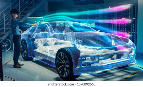 Engineer Wearing Augmented Reality Headset Working On New Electric Car Chassis Platform. 3D Graphics Visualization Virtual Model Of A Vehicle Is Tested In Digital Wind Tunnel.