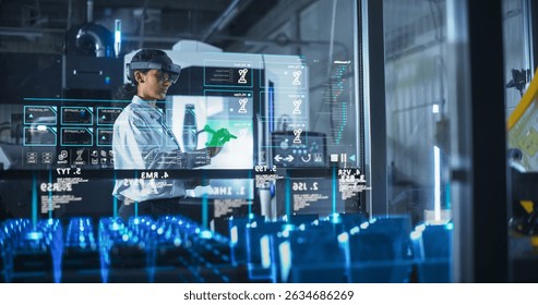 Engineer Wearing Augmented Reality Headset Operates Robotic Arm in a Factory, Interacting With Virtual Controls on a Transparent Interface. Advanced Machinery and Digital Displays. - Powered by Shutterstock - Get 15% off with code: PIKWIZARD15