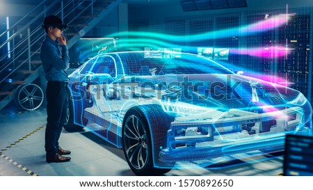 Engineer Wearing Augmented Reality Headset Working on New Electric Car Chassis Platform. 3D Graphics Visualization Virtual Model of a Vehicle is Tested in Digital Wind Tunnel.