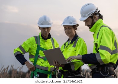 Engineer wearing safety uniform using tablet discussed plan about renewable energy at station energy power wind turbine. technology protect environment reduce global warming problems.