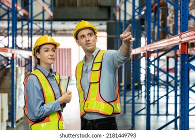 Engineer wearing safety vest controlling machine working talking with assistant engineer worker checking safety first for labour workers. Safety officer check box in warehouse. - Shutterstock ID 2181449793