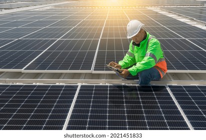 Engineer wearing unifrom and helmet inspect and check solar cell panel ,solar cell is ecology energy sunlight power installation for industrail ,alternative environment power concept.