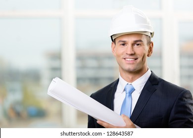 Engineer In White Hard Hat Hands Blueprint. Concept Of Successful Construction