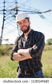 Engineer with white hard hat under the power lines.Engineer work at an electrical substation.