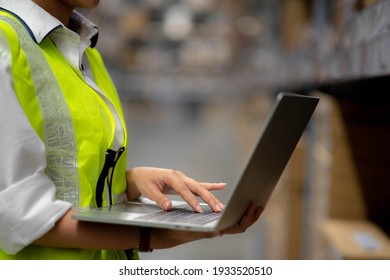 Engineer Woman Check Stock Details On Tablet Computer For Checking Goods And Supplies On Shelves With Goods Background In Warehouse, Logistic And Business Export.