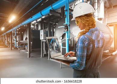  Engineer woman with laptop inspect modern industrial gas boiler room. Heating gas boilers, pipelines, valves. Blue toning with sunflare. Mixed media