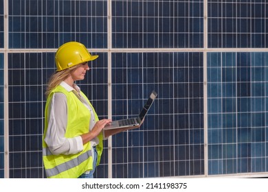 Engineer woman taking data from solar panels - Powered by Shutterstock